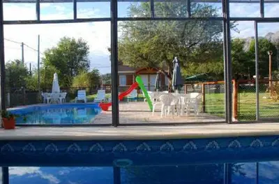a view of a swimming pool through a window at El Rincón de Iri-Nan in Merlo