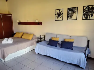 two beds sitting next to each other in a room at Posada Los Alamos in Merlo