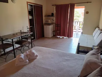 a hotel room with a bed and a table and chairs at Posada Los Alamos in Merlo
