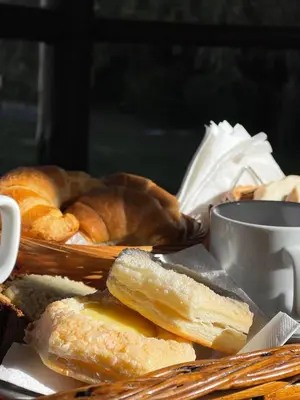 a basket of bread and pastries on a table at Posada Los Alamos in Merlo