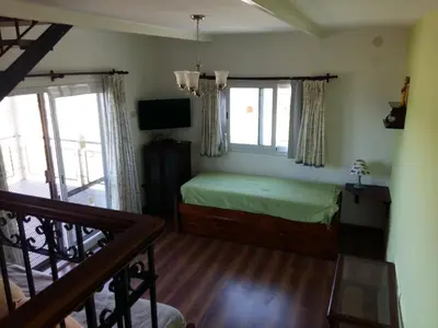 a bedroom with a bed and a television in it at Estancia de Campo in Estancia Vieja