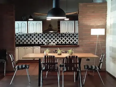 a kitchen with a table with chairs and a sink at Casa en Córdoba Zona Norte in Cordoba