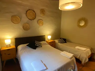 a bedroom with two beds and two lights on the wall at Casa en Córdoba Zona Norte in Cordoba