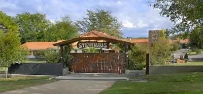 a gazebo with a gate in a yard at Cabañas Steinhaus in Villa General Belgrano
