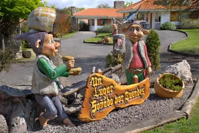 a group of three figurines sitting in a yard at Cabañas Steinhaus in Villa General Belgrano