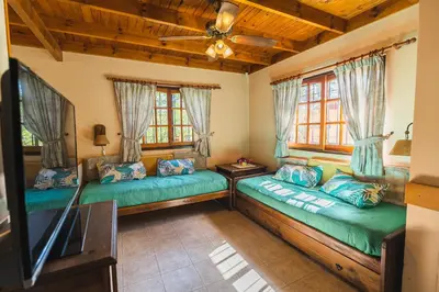 a living room with two couches and a tv at Cabañas Steinhaus in Villa General Belgrano