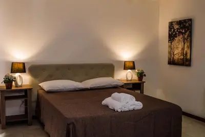 a bedroom with a bed with a towel on it at Rancho Grande Hotel in Villa General Belgrano