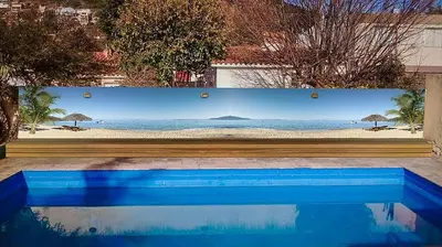 a wall with a picture of a beach at HOTEL COLONIAL in Villa Carlos Paz