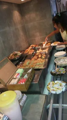 a buffet line with many different types of food at HOTEL COLONIAL in Villa Carlos Paz