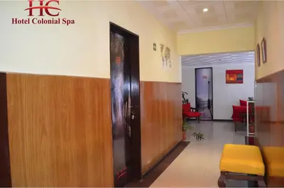 a hallway of a hospital with a door and chairs at HOTEL COLONIAL in Villa Carlos Paz