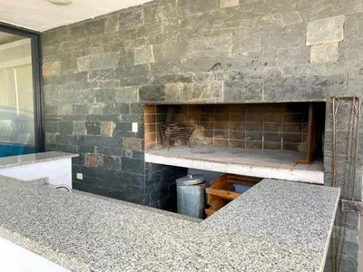 a brick wall with a fireplace in a room at Edificio Tempo in Villa Carlos Paz