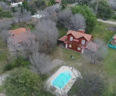 an aerial view of a house with a pool in the yard at Cabañas Peñihue in Carpintería