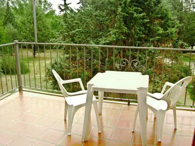 a white table and two chairs on a balcony at Costa Serrana Apart Hotel in Mina Clavero