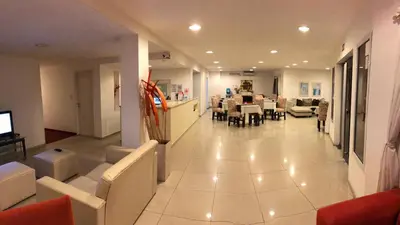 a living room with a couch and a dining room at Hosteria Arenas in Mina Clavero