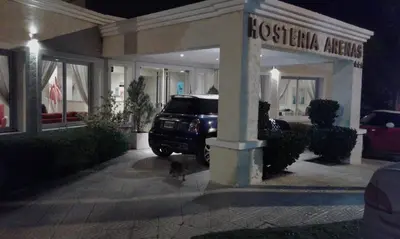 a truck parked in front of a store at night at Hosteria Arenas in Mina Clavero