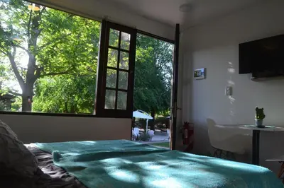 a bedroom with a bed and a window and a sink at Cabañas Cultura Serrana in Santa Rosa de Calamuchita