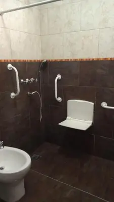 a bathroom with a toilet and a shower and a sink at Cabañas La Herradura in Villa Ciudad Parque