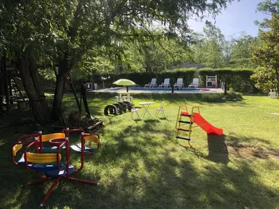 a group of playground equipment in a yard at Cabañas La Herradura in Villa Ciudad Parque