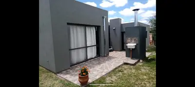 a house with a dog sitting outside of it at Waylla in Panaholma