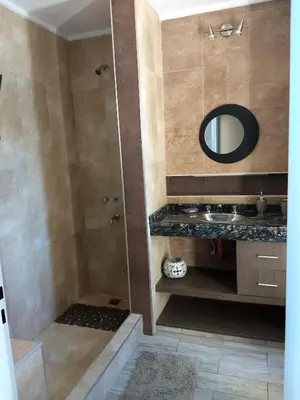 a bathroom with a shower with a sink and a mirror at Waylla in Panaholma