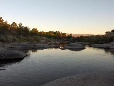 a river with rocks and the sunset in the background at Waylla in Panaholma