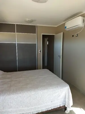 a bedroom with a bed with a white blanket at Waylla in Panaholma