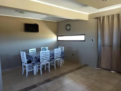 a dining room with a table and chairs and a clock at Waylla in Panaholma