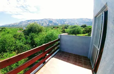 a balcony with a view of the mountains at Cabaña Negusa in Merlo