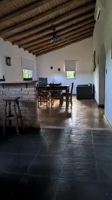 a large room with a table and benches in it at Cabaña Negusa in Merlo