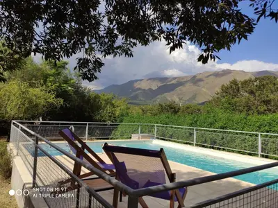 a couple of chairs sitting next to a swimming pool at Cabaña Negusa in Merlo