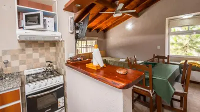 a kitchen with a counter top and a stove top oven at Cabañas Las Pircas in Villa del Dique