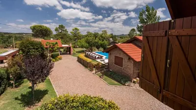 an overhead view of a backyard with a pool and a house at Cabañas Las Pircas in Villa del Dique