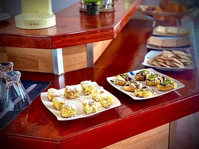 two plates of food sitting on a counter with plates of food at Hotel Colores in Merlo