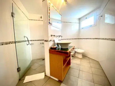 a bathroom with a sink and a shower and a toilet at Hotel Colores in Merlo