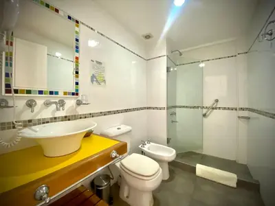 a bathroom with a sink and a toilet and a shower at Hotel Colores in Merlo