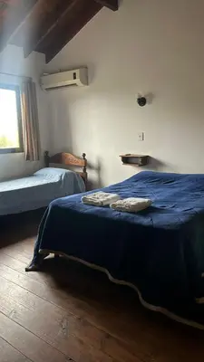 a bedroom with two beds and a window at Barranca Del Indio in Merlo