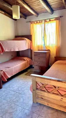 a bedroom with two bunk beds and a window at Cabañas El Trigal in Nono