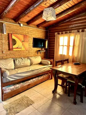 a living room with a couch and a table at Cabañas El Trigal in Nono