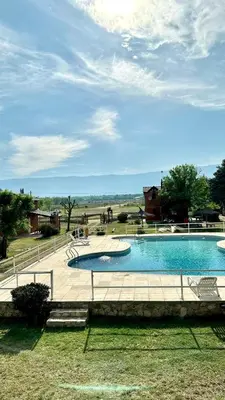 a large swimming pool in the middle of a park at Cabañas El Trigal in Nono