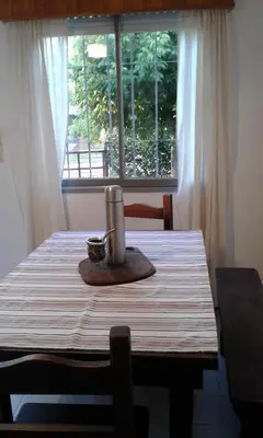 a table with a candle on it in front of a window at Soleaditos in Mina Clavero