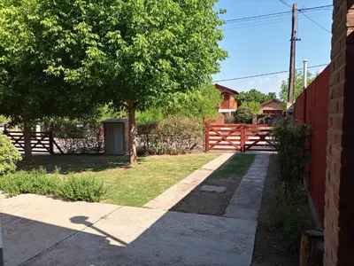 a fence and a tree in a yard at Soleaditos in Mina Clavero