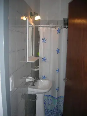 a bathroom with a sink and a shower curtain at Soleaditos in Mina Clavero