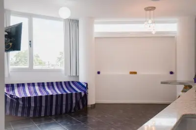 a living room with a couch and a window at Apart FJL in Río Cuarto