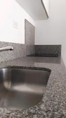 a stainless steel sink in a counter top at Apart FJL in Río Cuarto