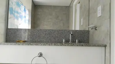a bathroom with a sink and a mirror at Apart FJL in Río Cuarto