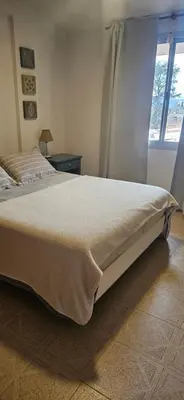 a bedroom with a large bed with a window at Depto VCP Rental in Villa Carlos Paz