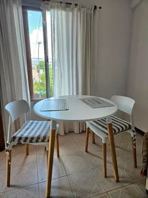 a table and two chairs in a room with a window at Depto VCP Rental in Villa Carlos Paz
