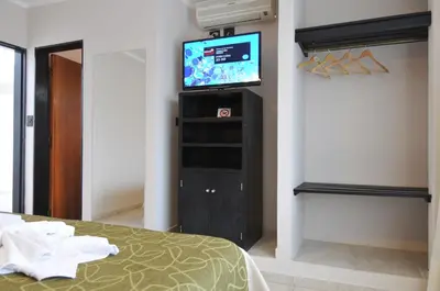 a room with a bed and a tv in a room at Madeo Hotel & Spa in Villa Carlos Paz