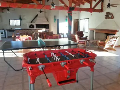 a ping pong table in the middle of a room at Cabañas Landhaus in Villa General Belgrano