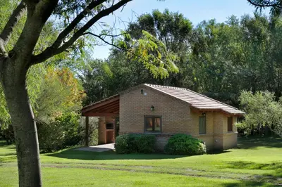 a small brick house in a yard at Cabañas Landhaus in Villa General Belgrano